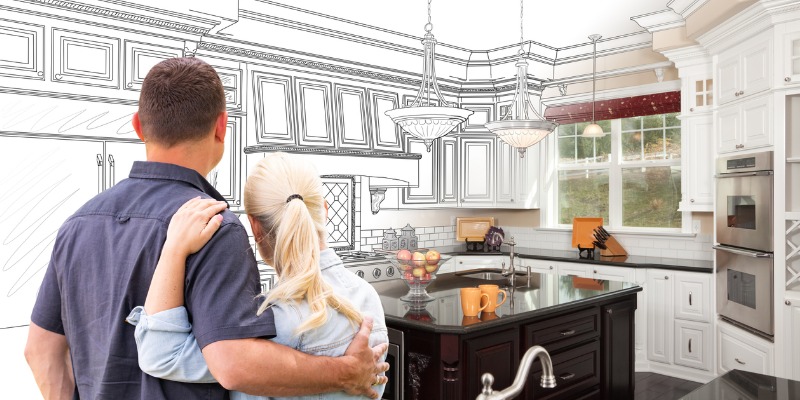 Couple looking at kitchen Renovation plan